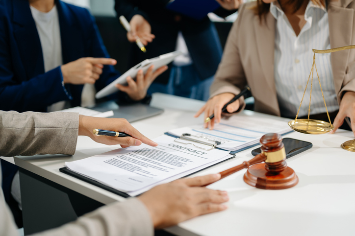 business people and lawyers discussing contract papers sitting at the table. Concepts of law, advice, legal services. in morning light